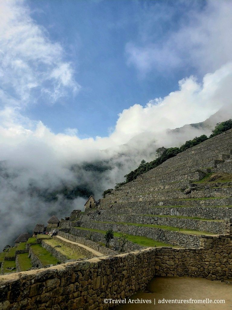 Terraces at Machu Picchu with fog in background