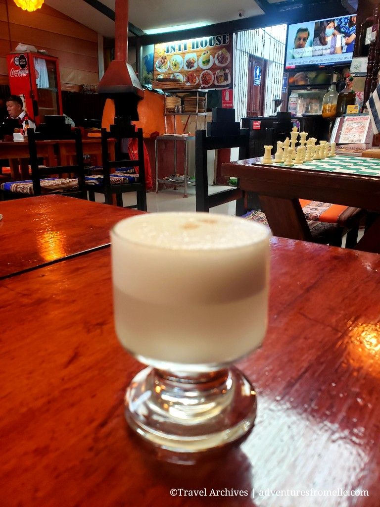 Pisco sour drink in foreground in bar at Aguas Calientes